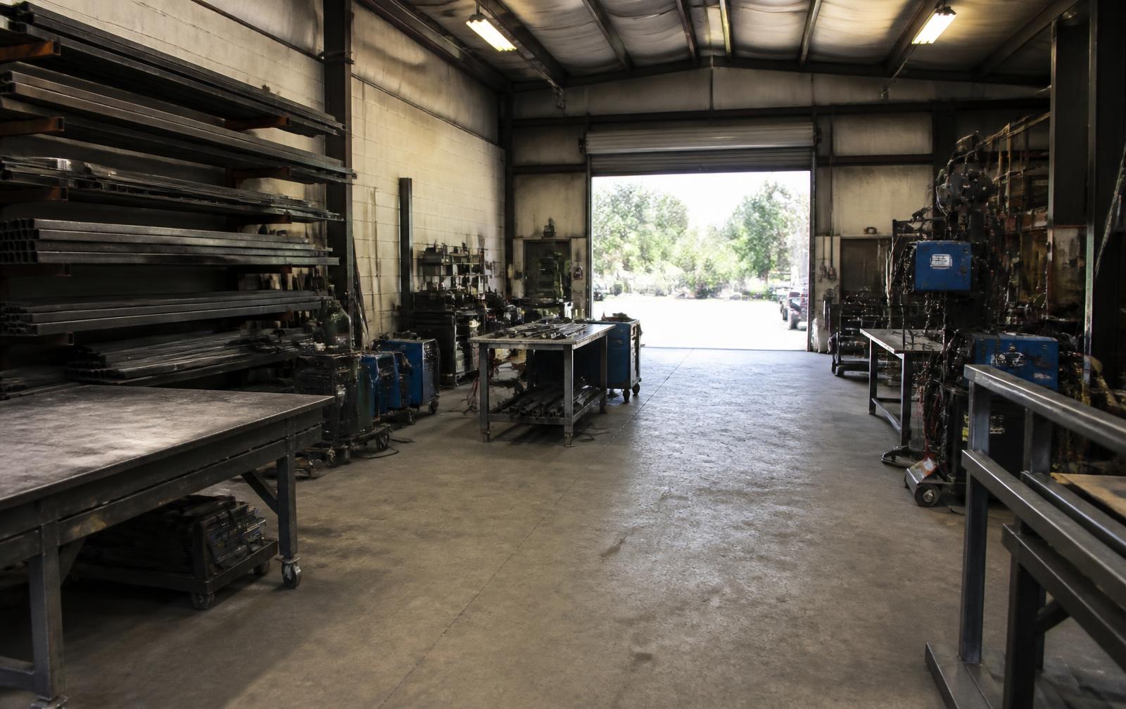 Fabrication shop floor with steel stock and work benches