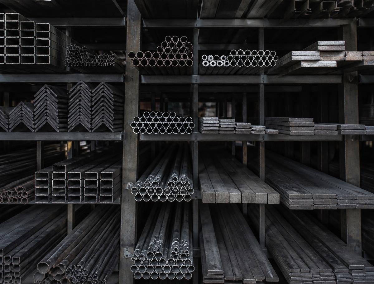 Steel tube, angle, and flat bar stock racked in the shop